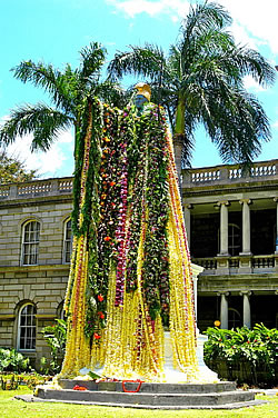  King Kamehameha, the chief who united all the Hawaiian islands, decked in flowers on his birthday.  Photo by Milton Diamond. 