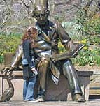 girl posing next to statue of Hans Christian Andersen