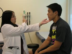 Medical students Delores Lee and Christoper Lau practice physical exams at JABSOM