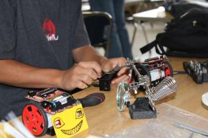 A student getting his sumo bot ready for competition.