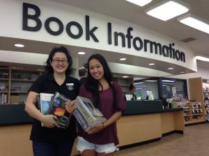 Student Allyson Kim (rt)  gets help gathering her free textbooks