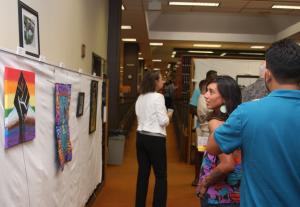 Students, faculty and guests enjoy the 'Social Justice' art exhibit.