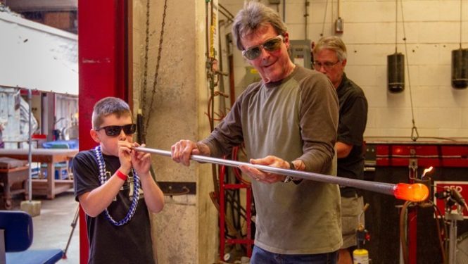 Professor Rick Mills assists Make-A-Wish kid with glassblowing