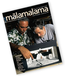 cover of magazine shows two men bending over a model of a theatrical set