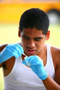 Student preparing limu specimen