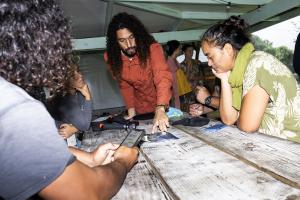 Dr. Cliff Kapono talks with members of Vai Ara O Teahupoʻo. Credit: Todd Glaser.  