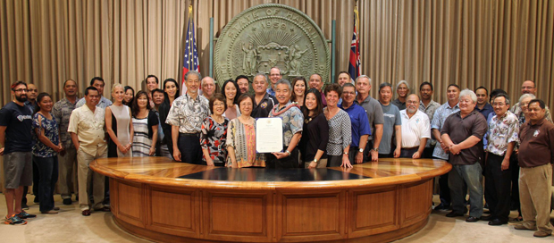 large group of people standing with Hawaii Gov. Ige