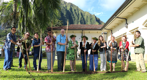 large group of people holding sticks