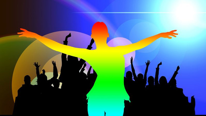 rainbow colored silhouette in front of an audience