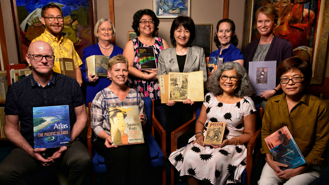 Smiling librarians holding books