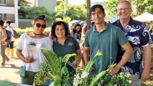 four people in a booth at Welina Manoa