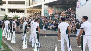 U H cheer squad in front of crowd at Campus Center