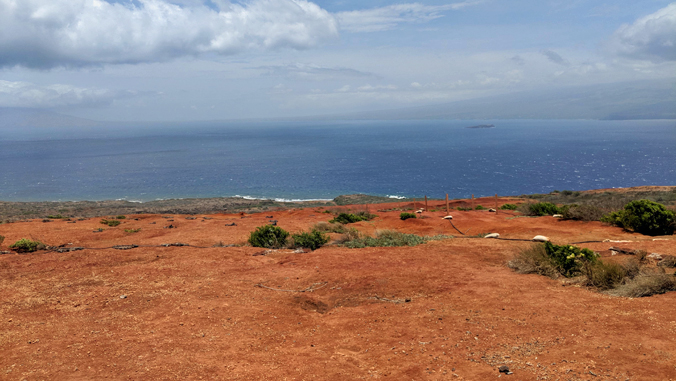 Kahoolawe island coastline with island of Maui in the distance
