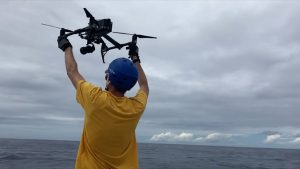 Man releasing a drone at sea