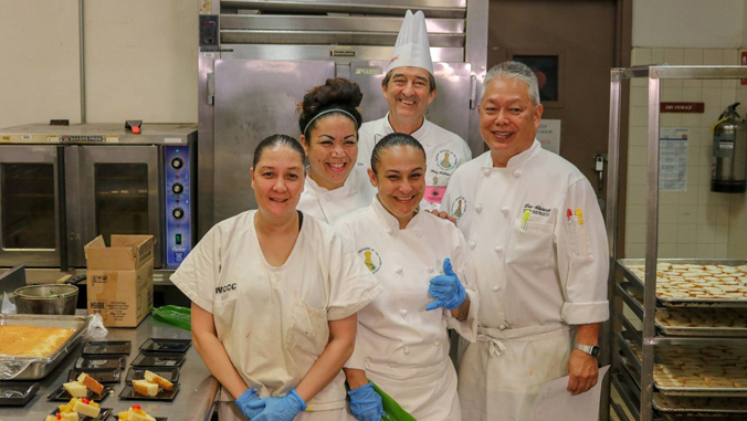 group shot of people smiling in a kitchen