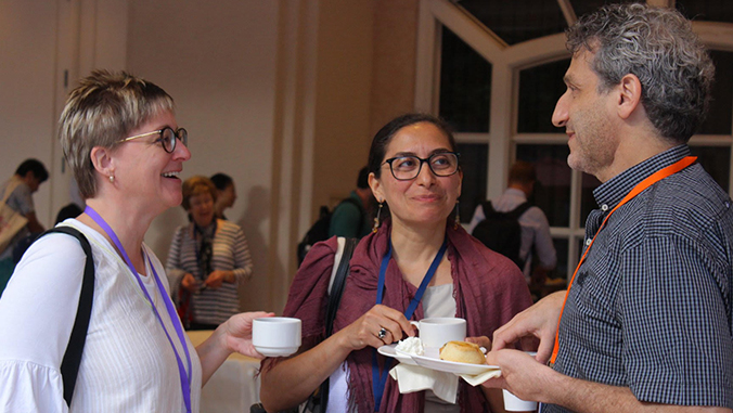 Two women and a man talking