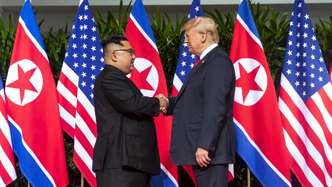 North Korean leader Kim Jong-il shaking hands with U.S. President Donald Trump.