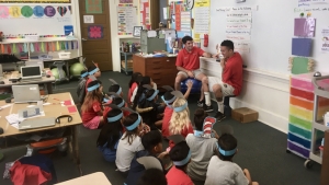 hilo students reading dr. seuss to elementary students