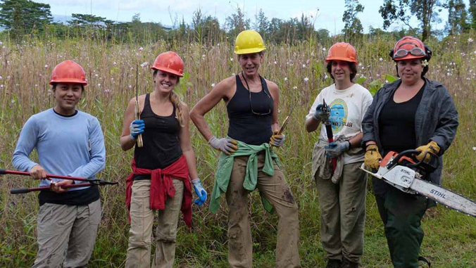 five women smiling with tools