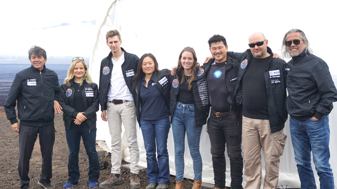 8 people standing in front of white dome on Mauna Loa