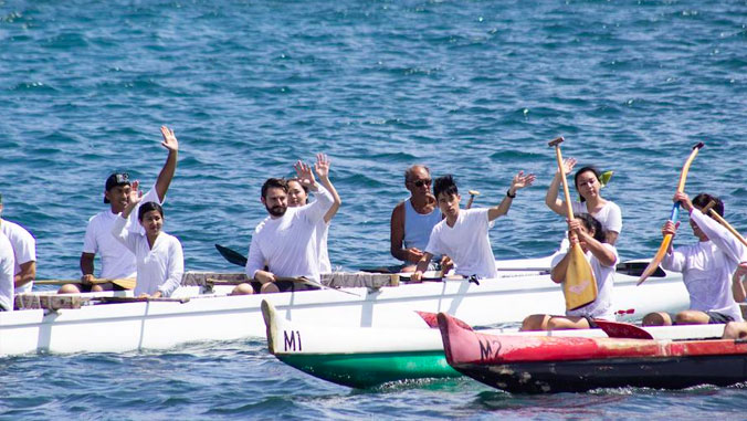 medical students waiving from canoes