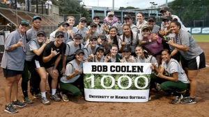 softball team holding a sign that says Bob Coolen 1000