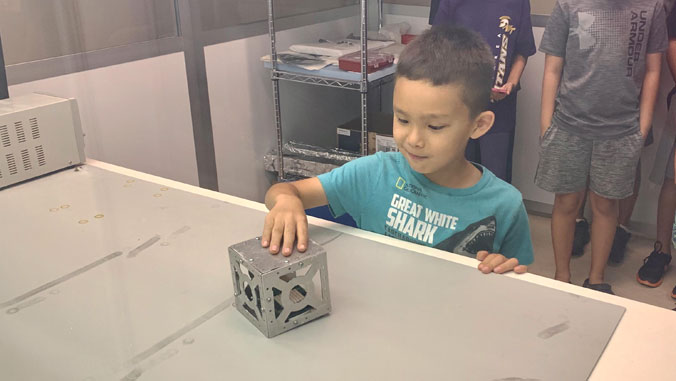 boy touching cube