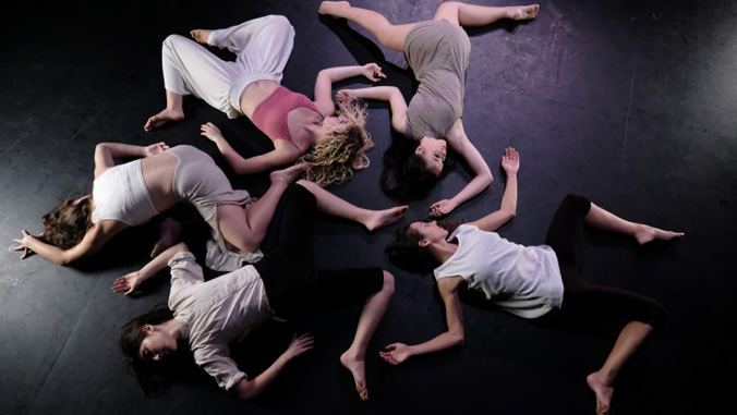 dancers laying in circle formation