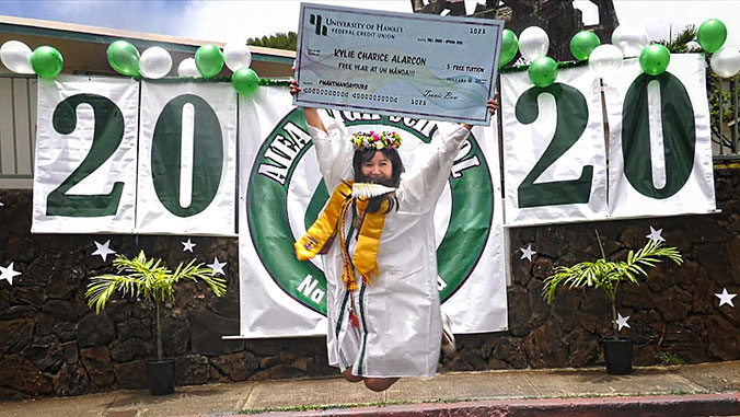 student celebrating with big check