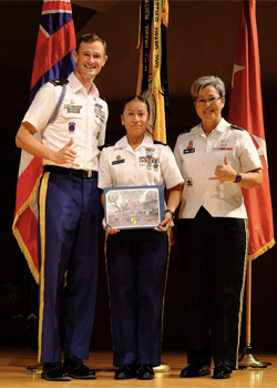 three people in uniforms smiling