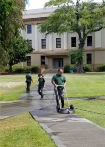 Facilities crew cleaning sidewalks