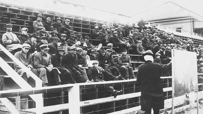 black and white photo of students sitting in bleachers