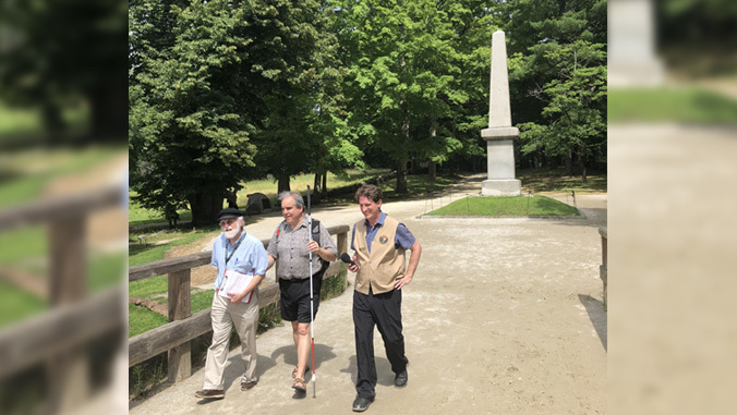 three people walking near monument