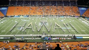 hundreds of marching band students form the word Hawaii