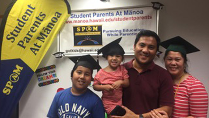 Family in front of the Student Parents At Manoa sign