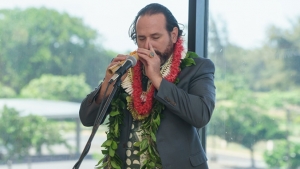 man playing nose flute