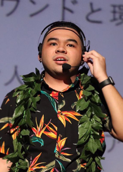 person with an aloha shirt and microphone