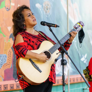 Person singing and playing a guitar