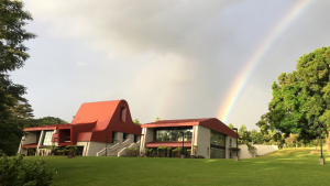 Exterior of building with a rainbow in the sky