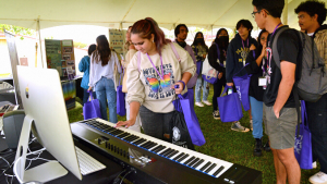 High school student trying electronic keyboard