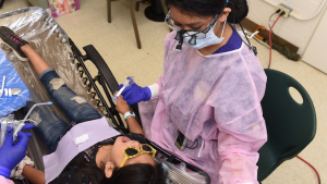 child receives a screening from a dental health provider