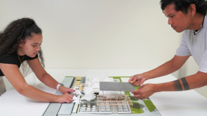 Two people assembling a model