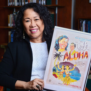 woman holding Aloha movie poster
