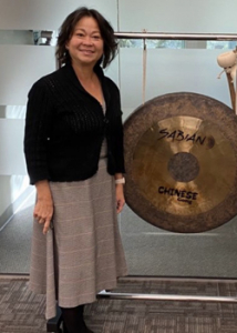 person standing next to a gong