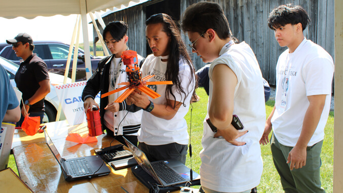 U H Maui students working on satellite
