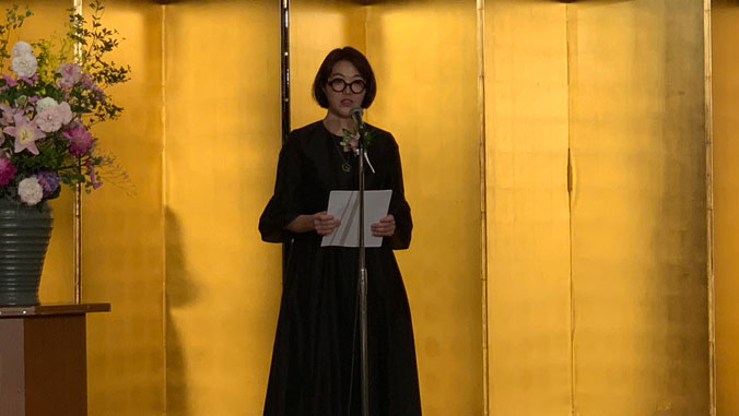 Mari Yoshihara giving a speech