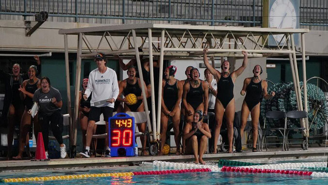 Women water polo team cheering 