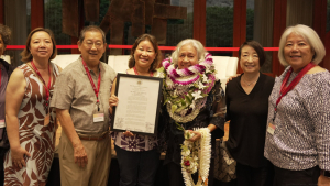 people pose for a photo and award