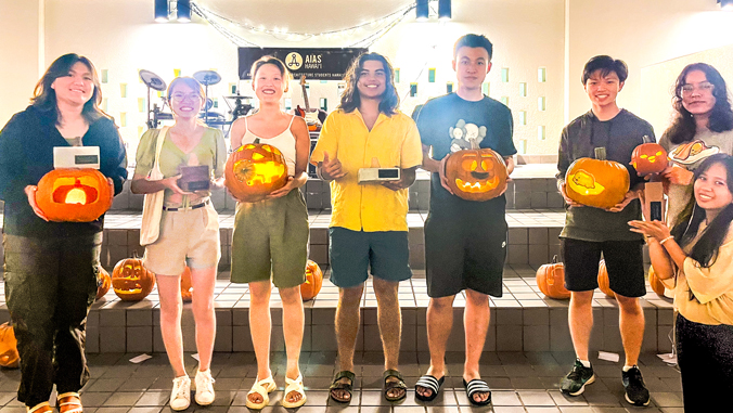 people holding pumpkins