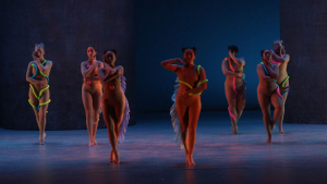 Dancers perform in scene on stage 